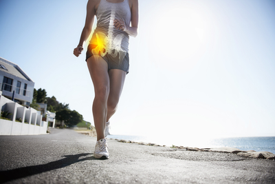 Woman running with pain in her hip